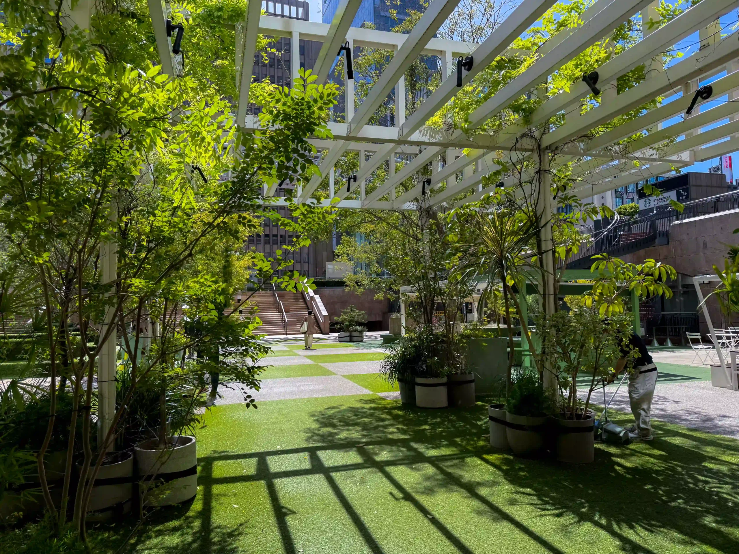 Landscaper maintaining green courtyard at a commercial property